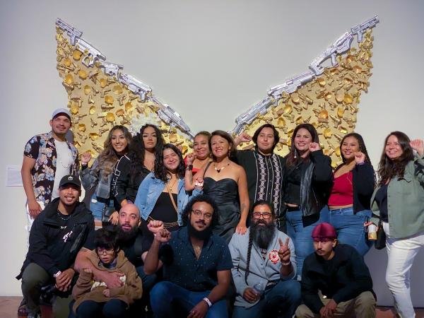 Image from SomArts - Supporters of artist Alicia Cruz, pose in front of her...