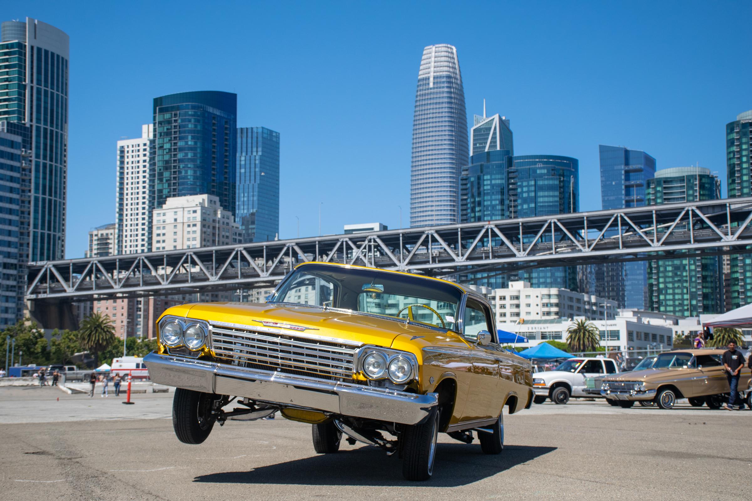 A 1962 gold Impala is displayed in the pit before the hopping contest. San Francisco, California. August 20, 2022. Photo by Karem Rodriguez.