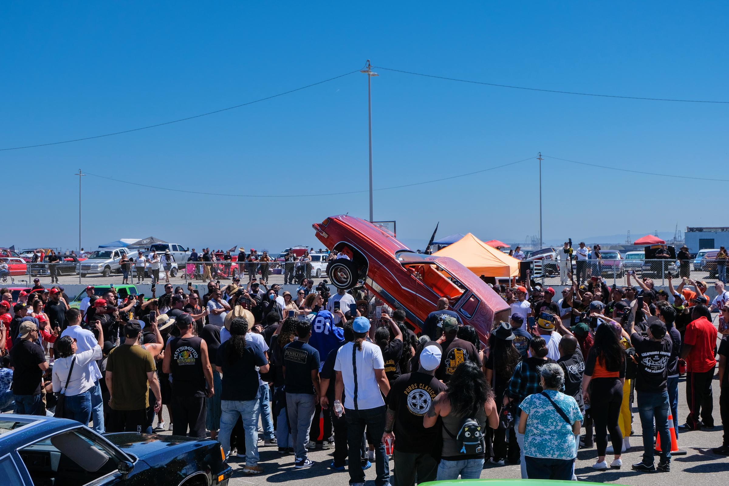 Lowriders Show: King of the Streets - Spectators watch while a red lowrider rises during the...