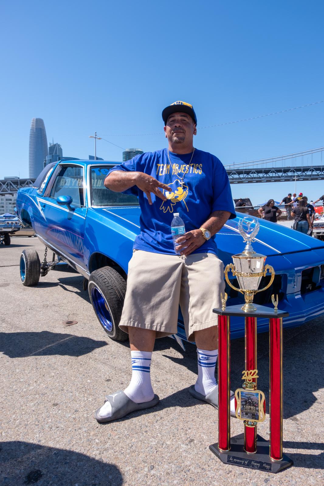 Lowriders Show: King of the Streets - Majestic Snow from Team Majestics, sits on the hood of...