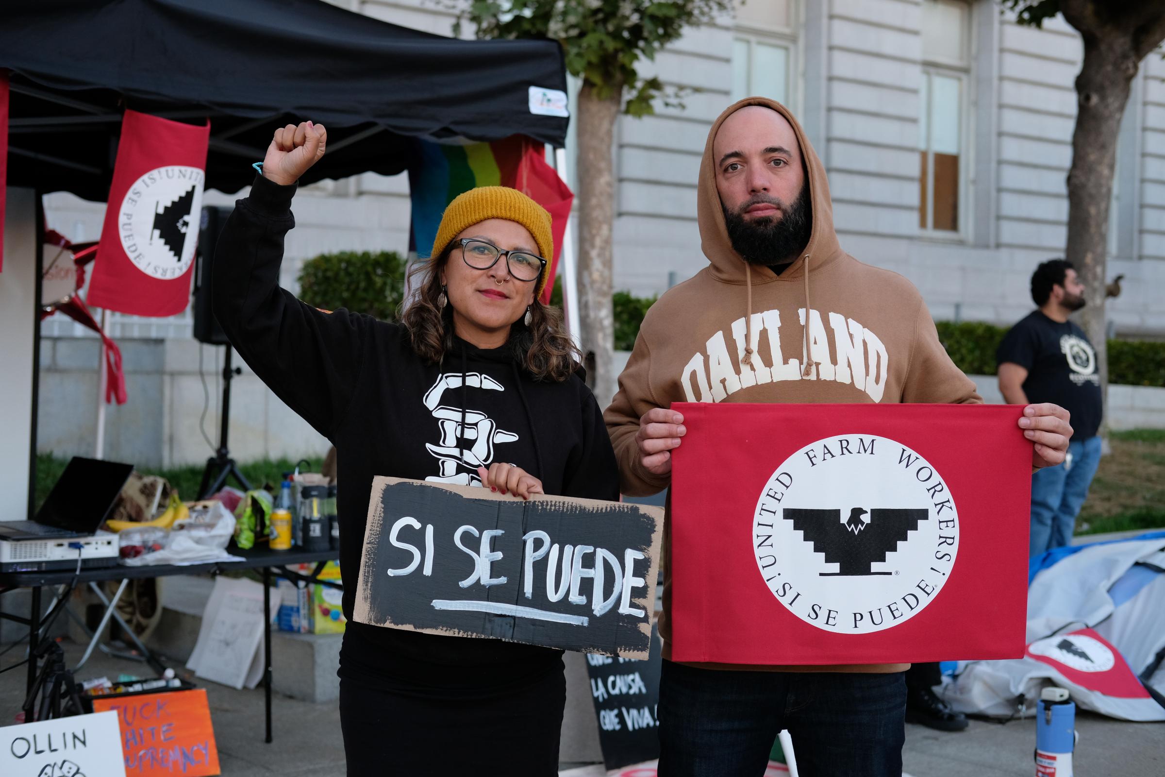 Alicia Cruz, left, and Sergio Monleon, right; two of the organizers of the vigil in support of farmworkers in San Francisco, pose while holding a...