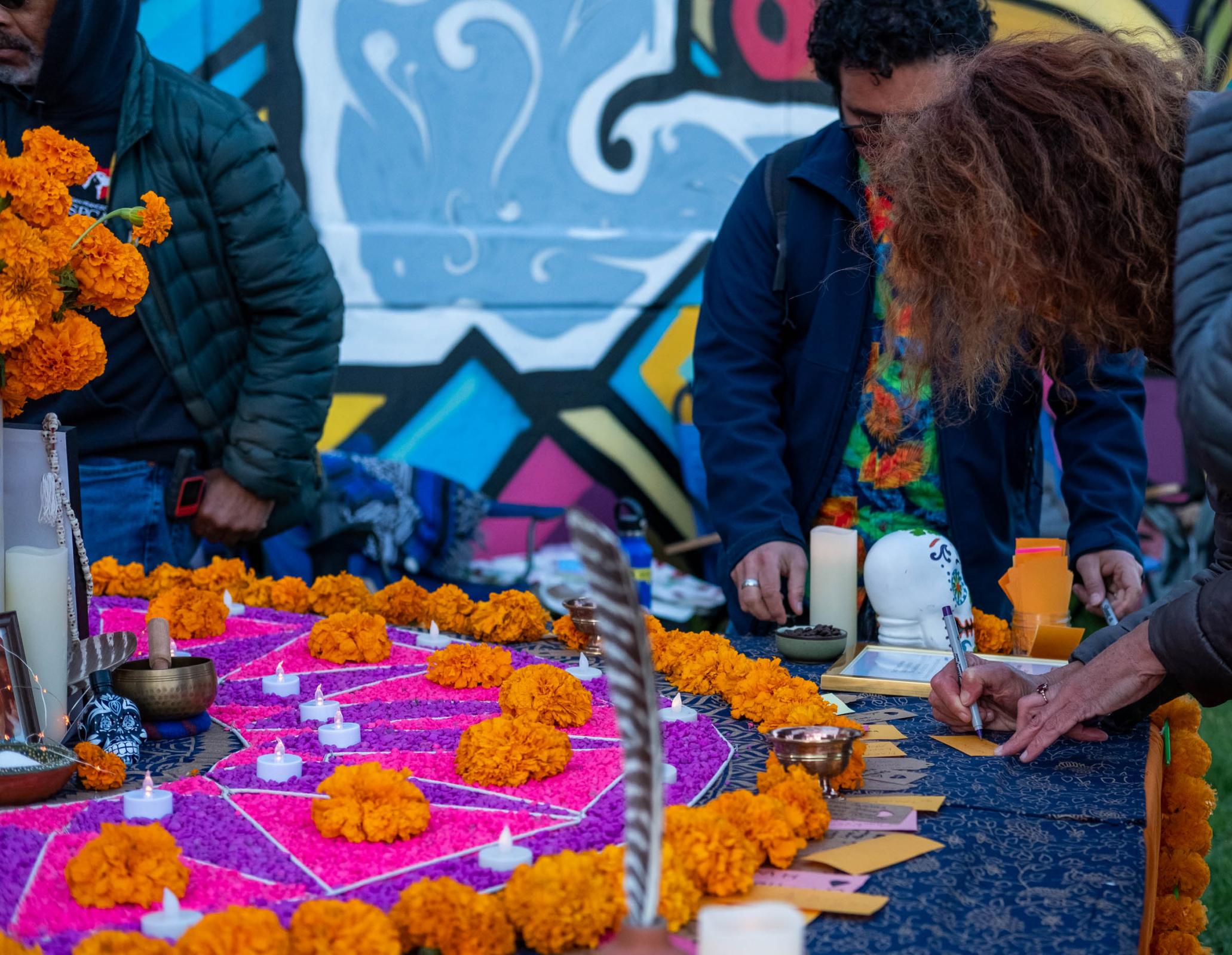 Visitors to the Festival of Altars write messages to their loved ones who have passed away. San Francisco&rsquo;s Potrero del Sol Park....