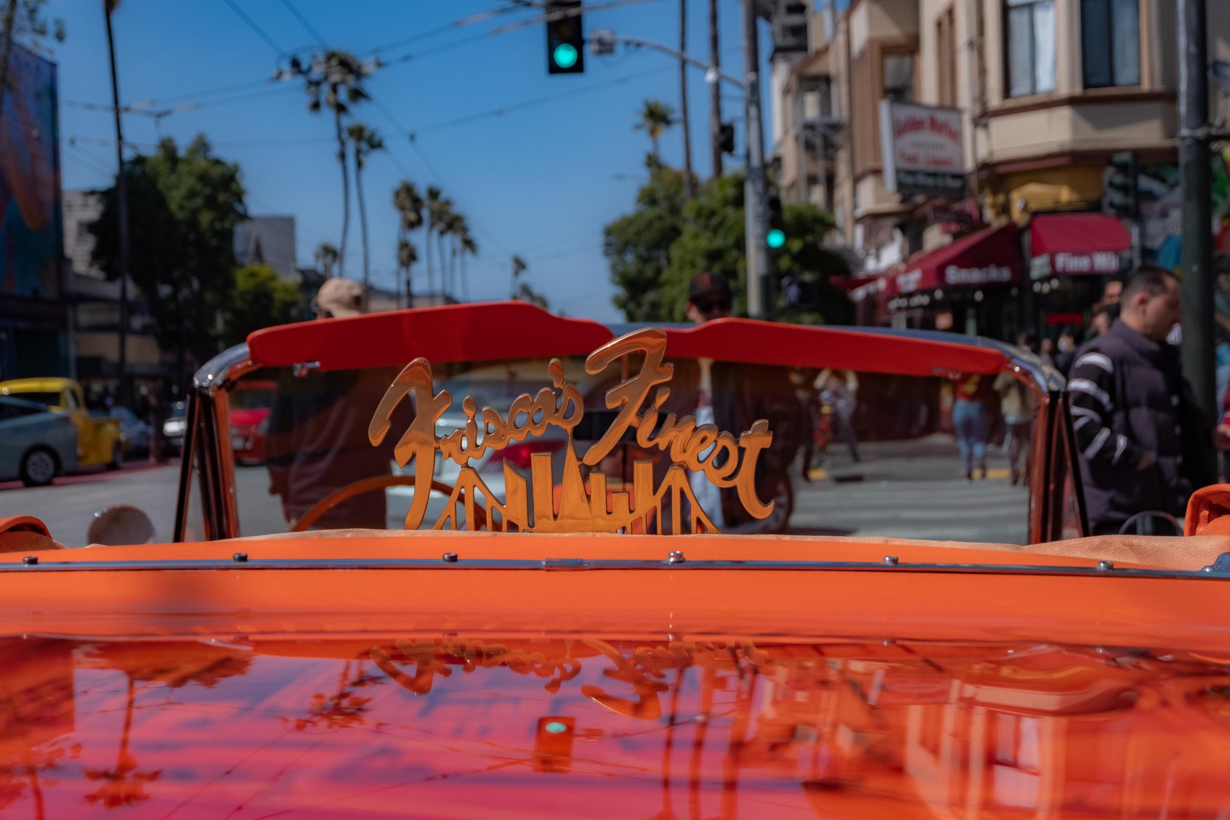  A &ldquo;Frisco&rsquo;s Finest&rdquo; sign stands out on the back of an orange lowrider parked on Mission street during the event...