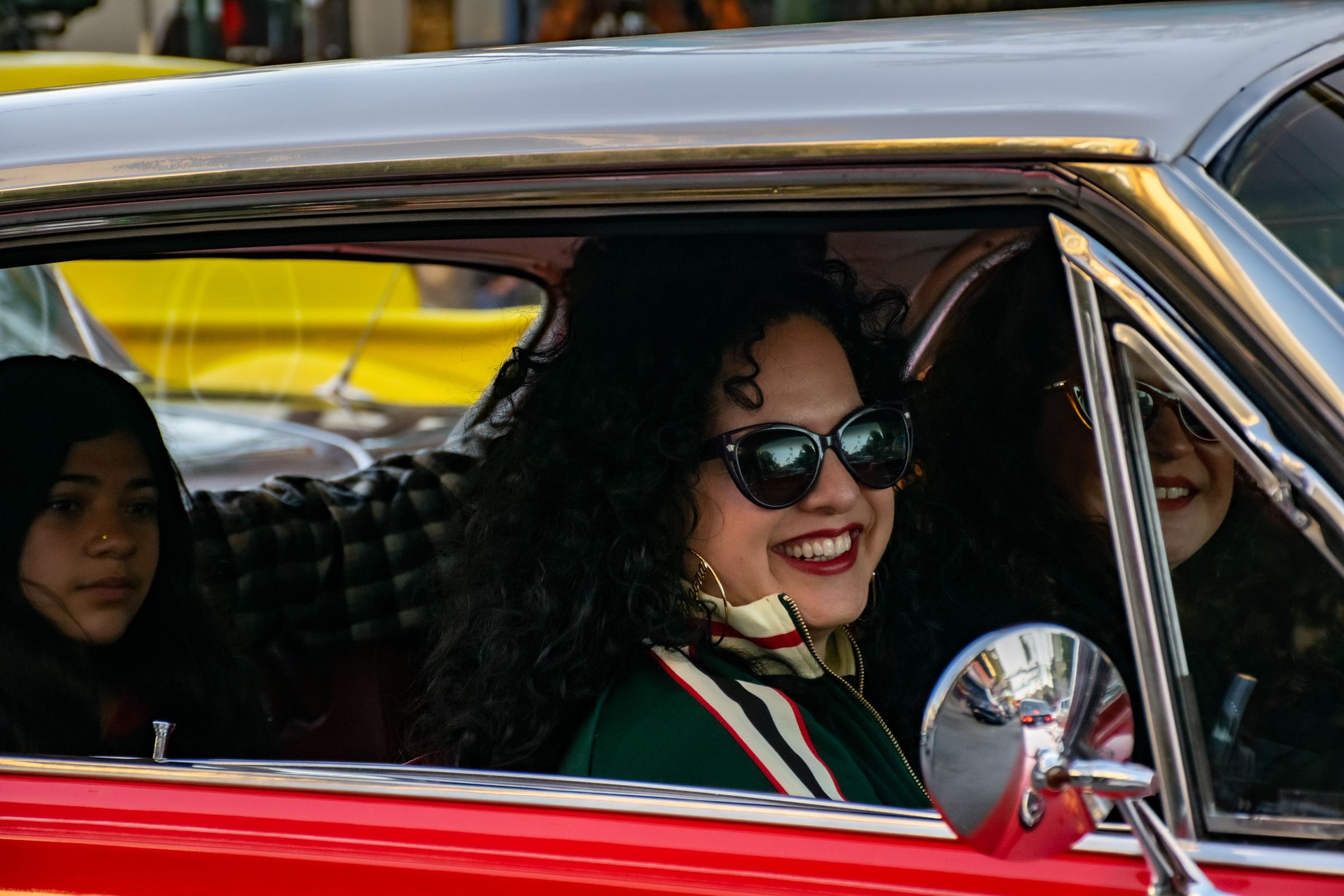 Lowriders Cinco de Mayo Show -  A lowrider passenger smiles while cruising down Mission...