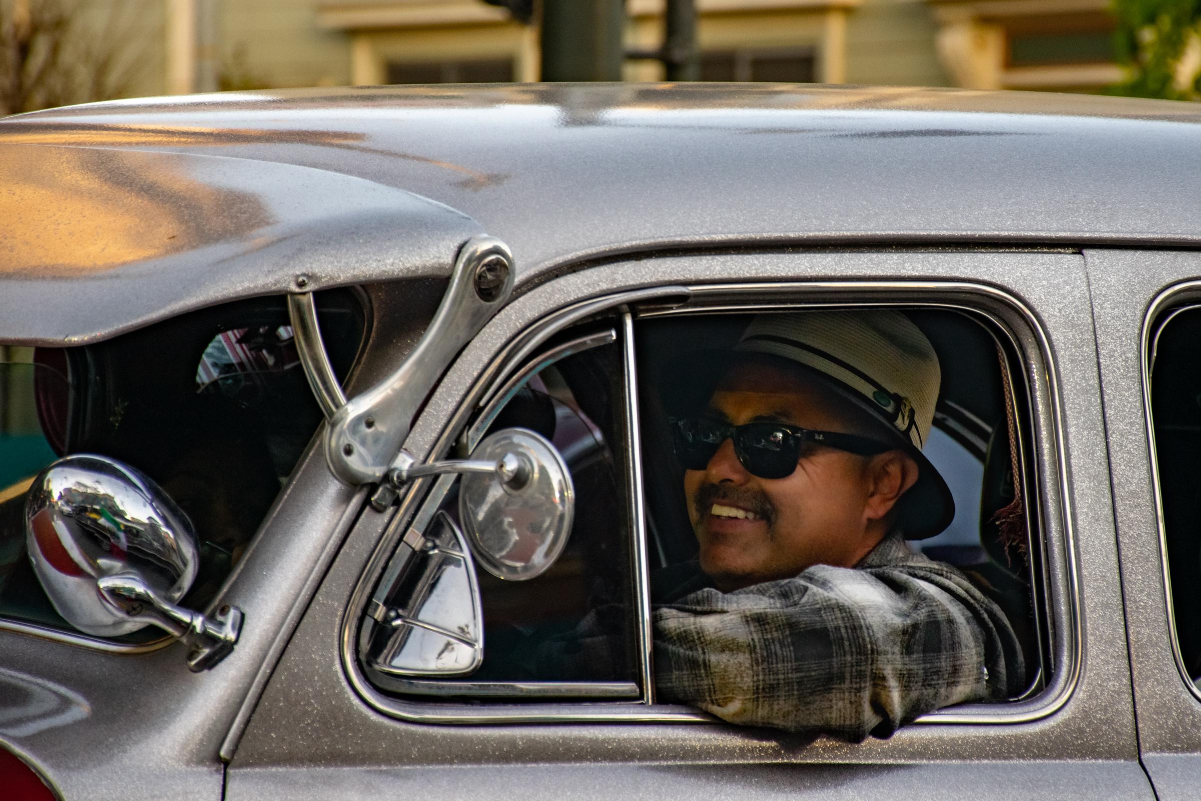 Lowriders Cinco de Mayo Show -  A lowrider driver smiles while cruising down Mission...