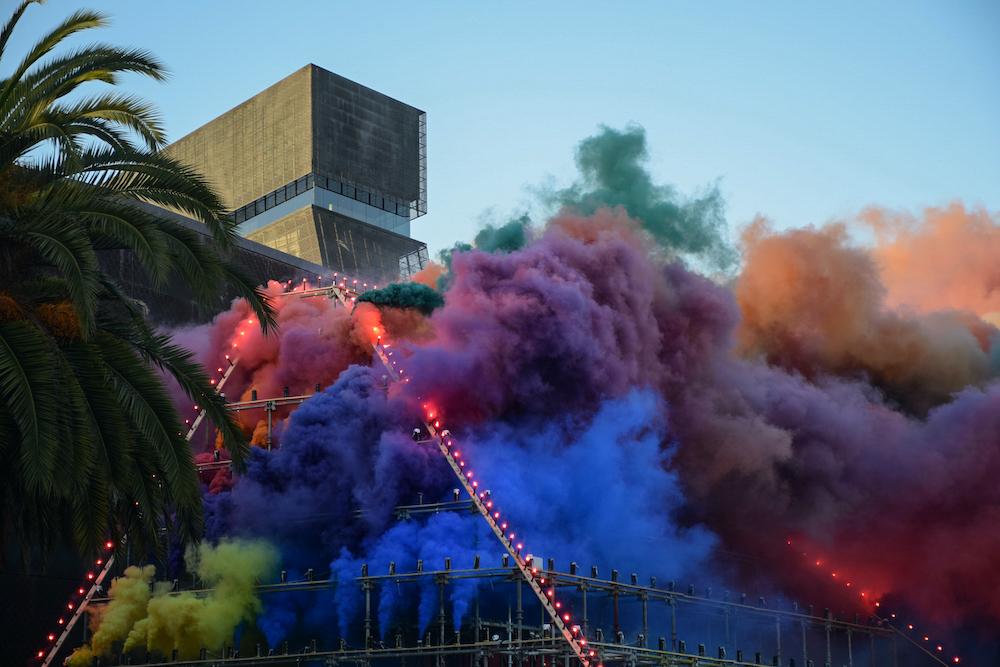 Multicolored smoke erupts from a massive 27-foot high pyramid structure as part of the live art exhibit, Forever de Young, presented by the artist...