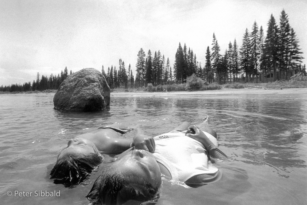 Thumbnail of From Project: RETURN TO NITASSINAN: Innu boys lie on a sandbar in Lake Melville, cooling off from the July heat and temproarily escaping the pathos of village life, Sheshatshiu, Nitassinan/Labrador. 
