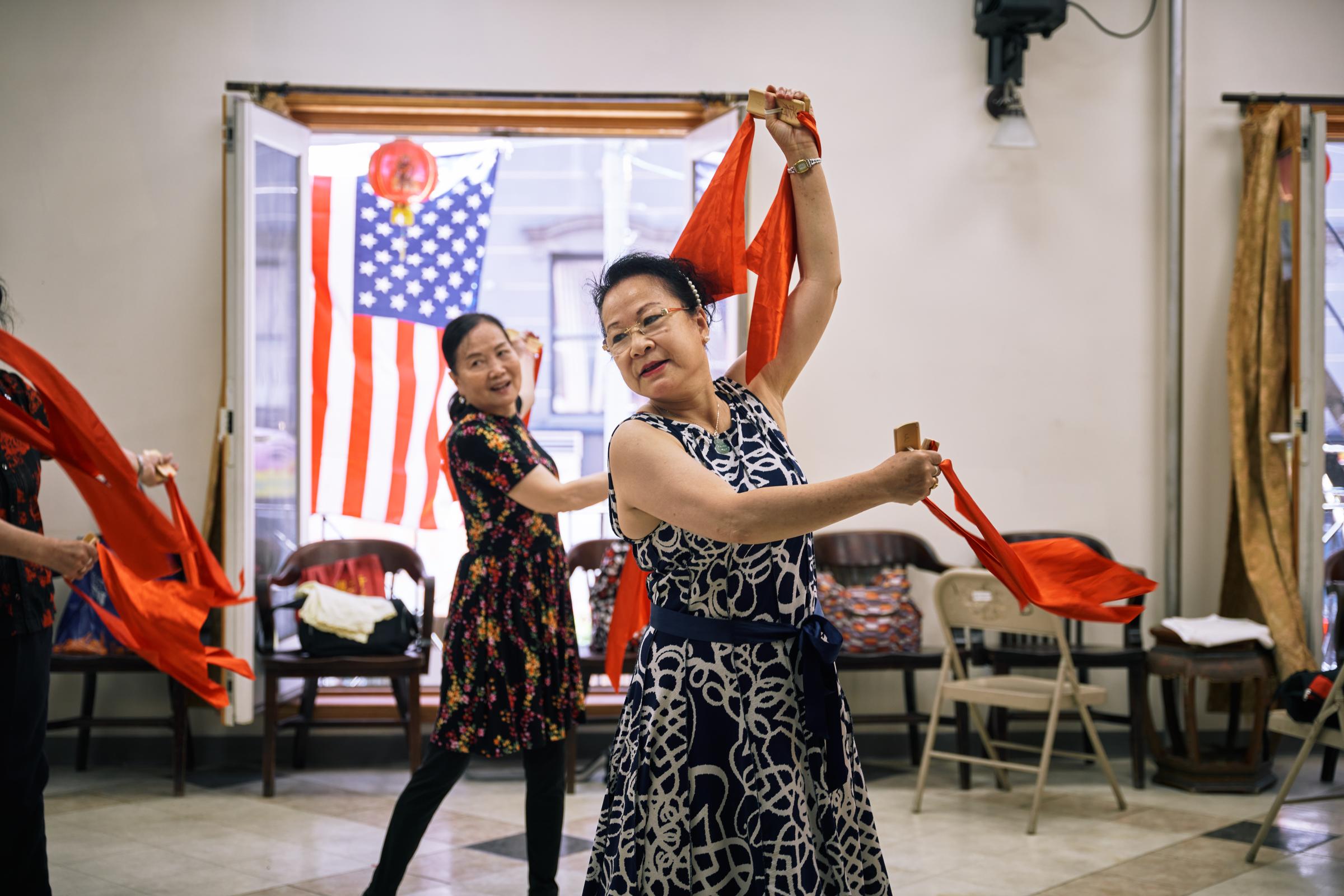 Aizhen Huang practiced dancing with the group in downtown Chinatown, New York on June 30, 2022.