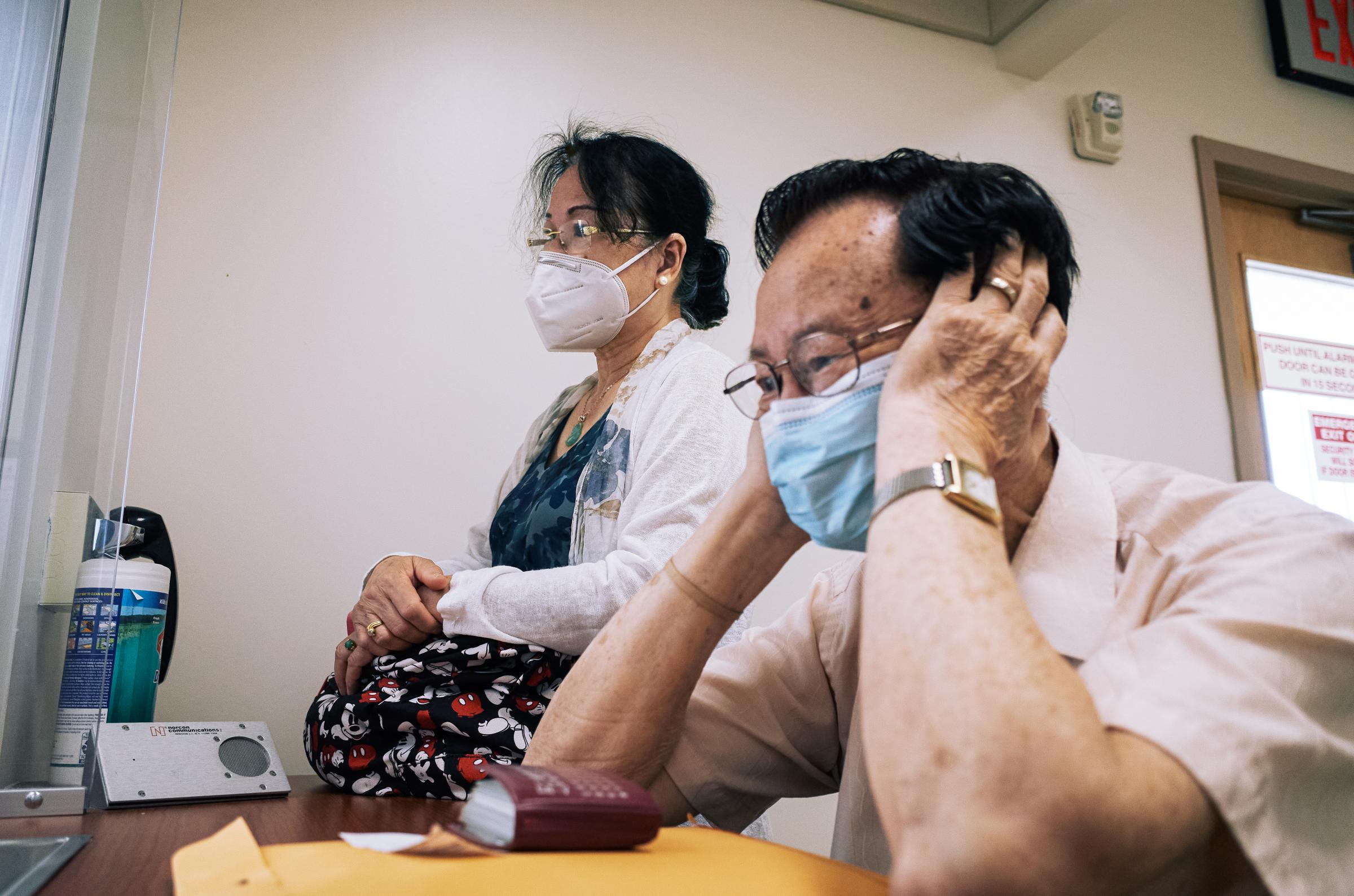 East Harlem - Aizhen Huang and Yihui Mei rested on couch in the living...