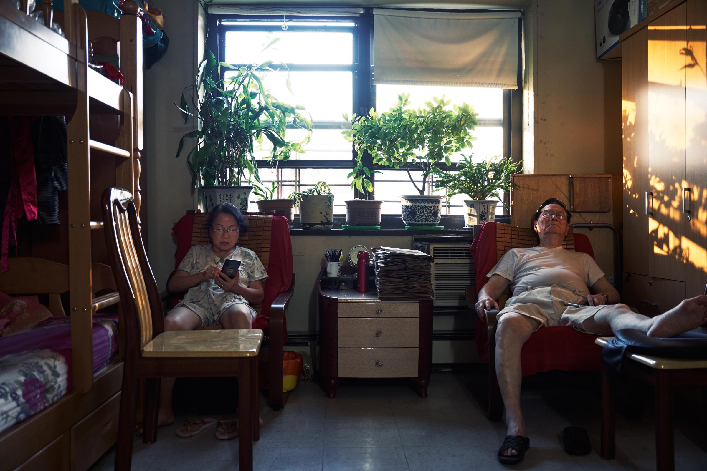 East Harlem - Aizhen Huang and Yihui Mei rested on the couch in the...