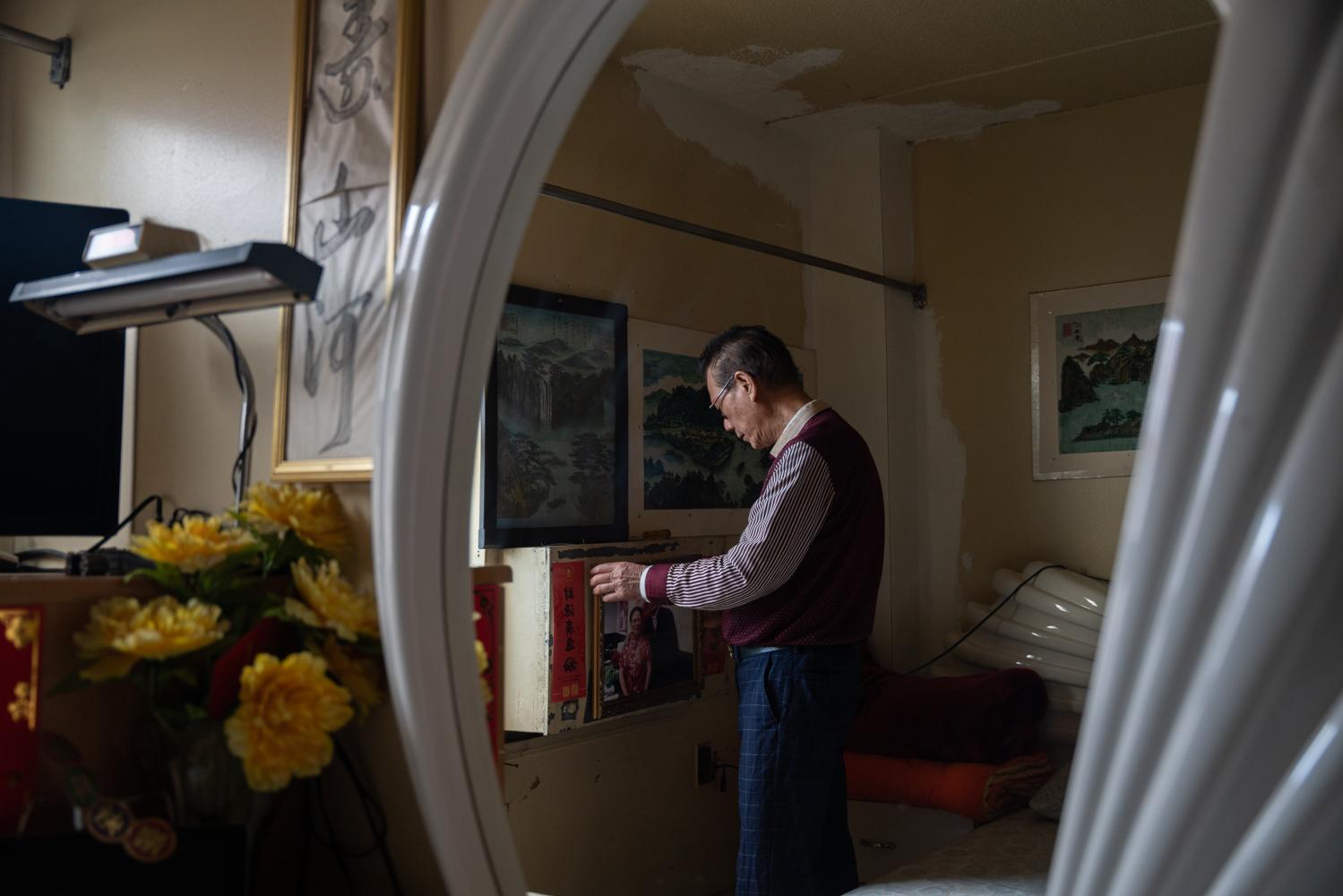 East Harlem - Yip Tsinghua organized photos of his wife who passed away...