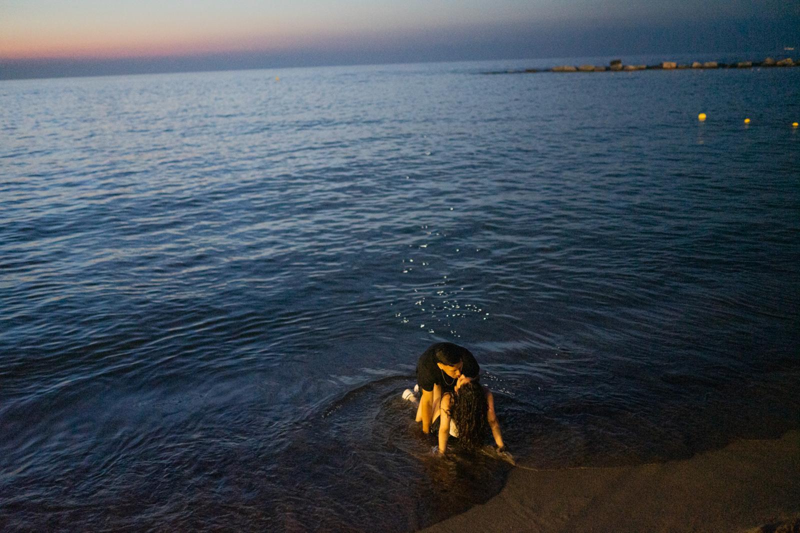 A couple kisses on the beach th...elona, Spain, on June 24, 2022.