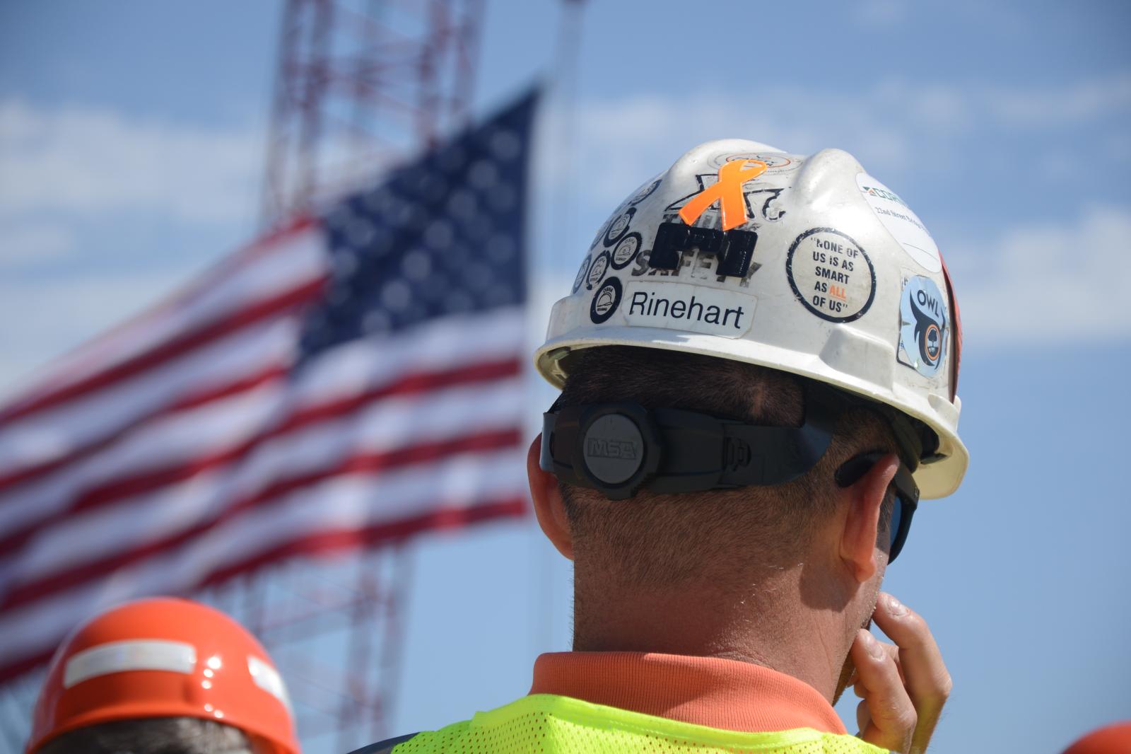 Image from Moments - Construction worker, Geoff Rinehart, listens to a...