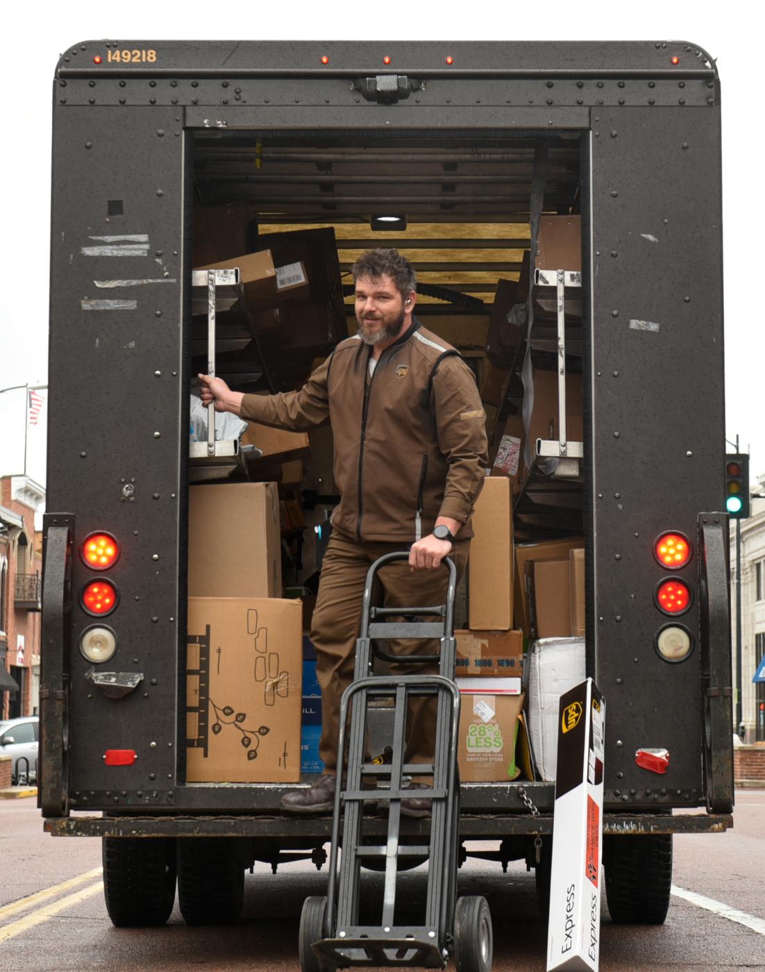 Image from Moments - UPS employee Corey Powers sorts deliveries on Thursday,...