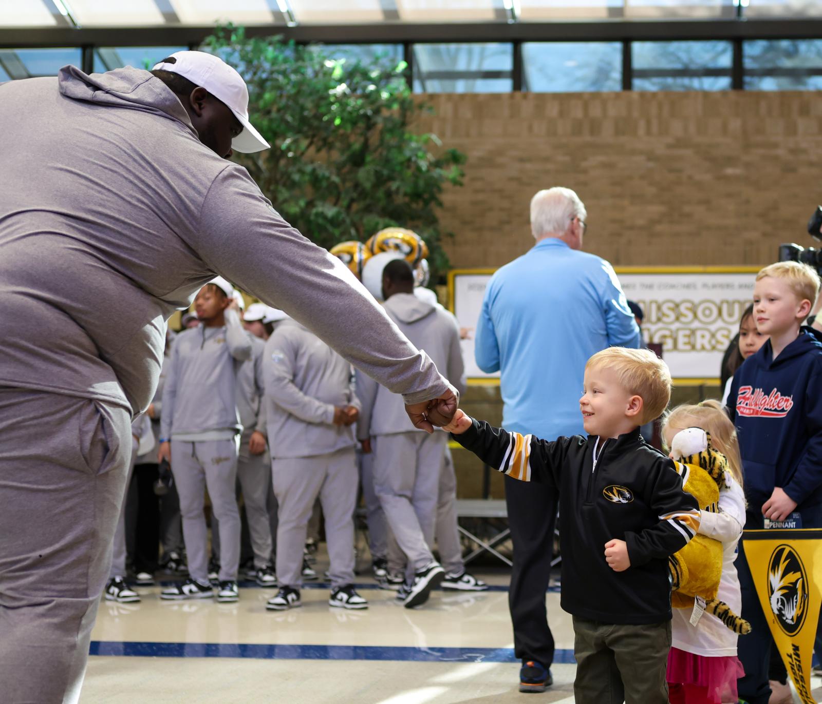 Image from Moments - James Sunchich, 5, gives Missouri Defensive Line coach Al...