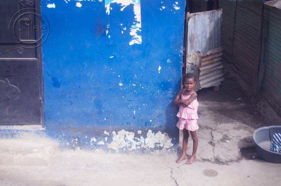  Haitian girl outside of her ho...l house and living conditions. 