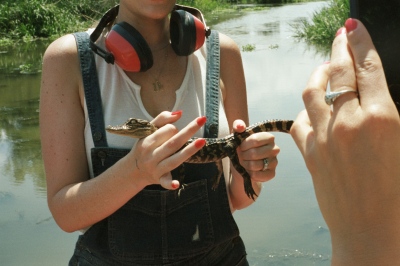 Image from xi: State of the Union - Sara holding a baby alligator, Jean Lafitte Swamp, LA