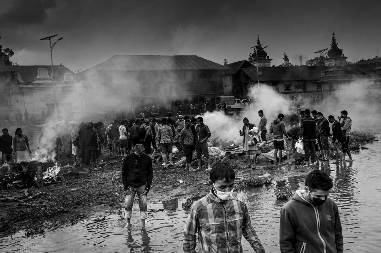 Earthquake aftermath -                 Funeral for earthquake victims next to a...