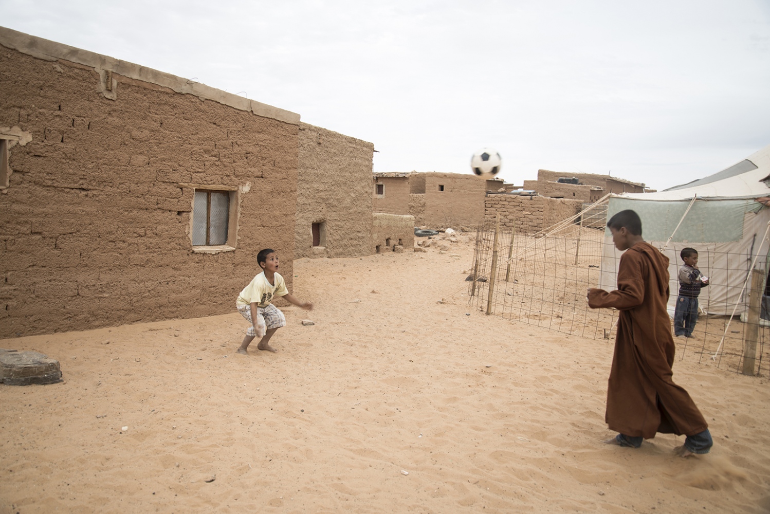 Behind The Wall, life of the Sahrawi -  Kids playing soccer with a goal made of stones. The boy...