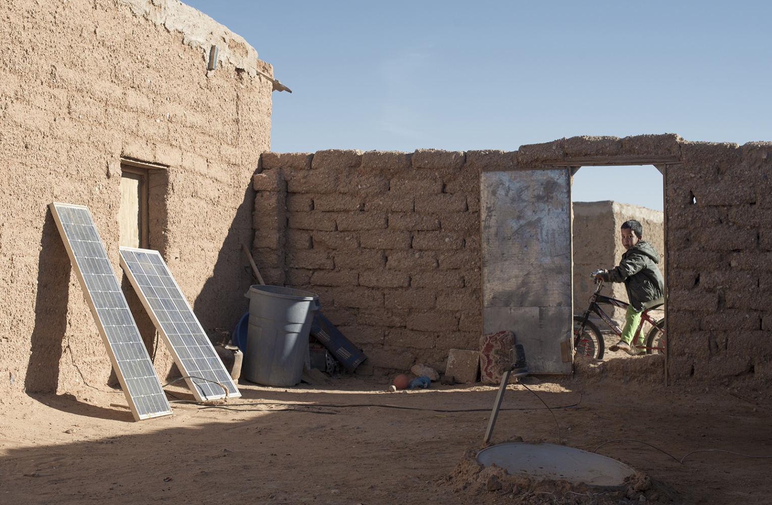 Behind The Wall, life of the Sahrawi -  A tipical Saharawi garden with solar panels and a...