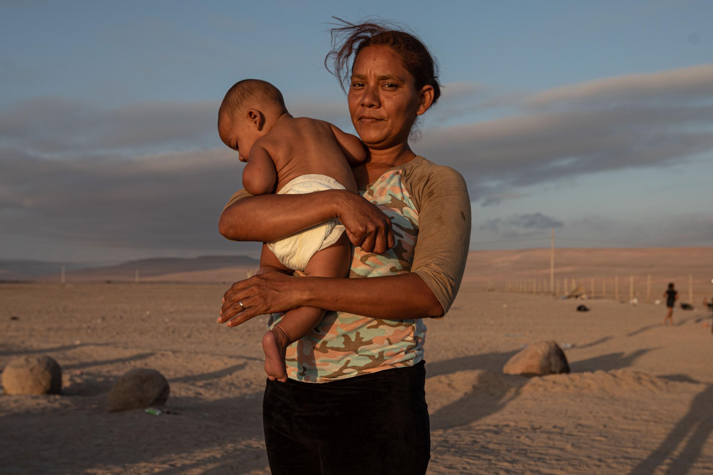 Fear, cold and xenophobia: broken dreams on the Chilean border - Jimir Coromoto (51), is photographed with his son on the border between Chile and Peru, on...