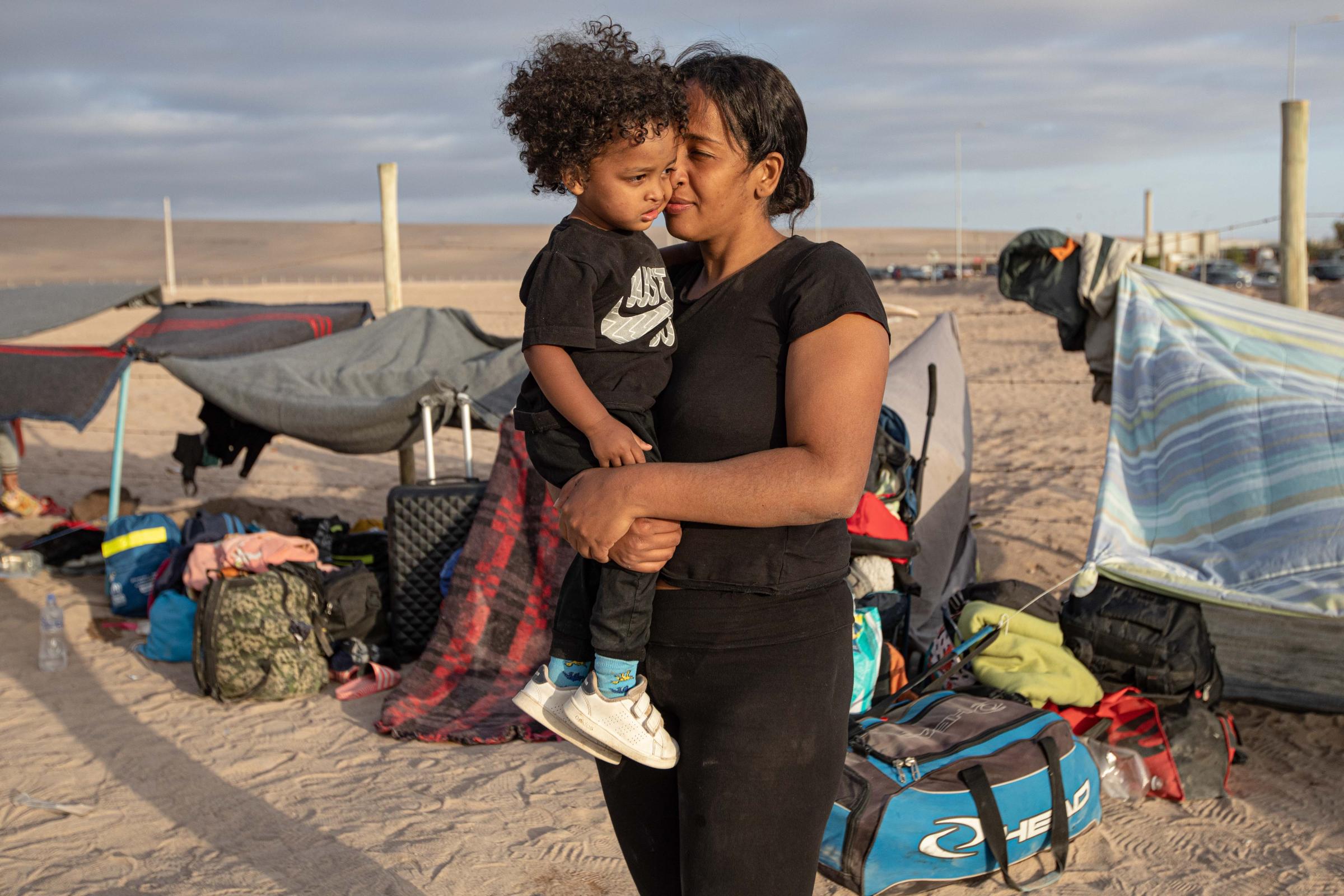 Fear, cold and xenophobia: broken dreams on the Chilean border - ARICA, CHILE - MAY 2: Jesica Toro (30), a Venezuelan migrant, holds her son waiting to enter the...