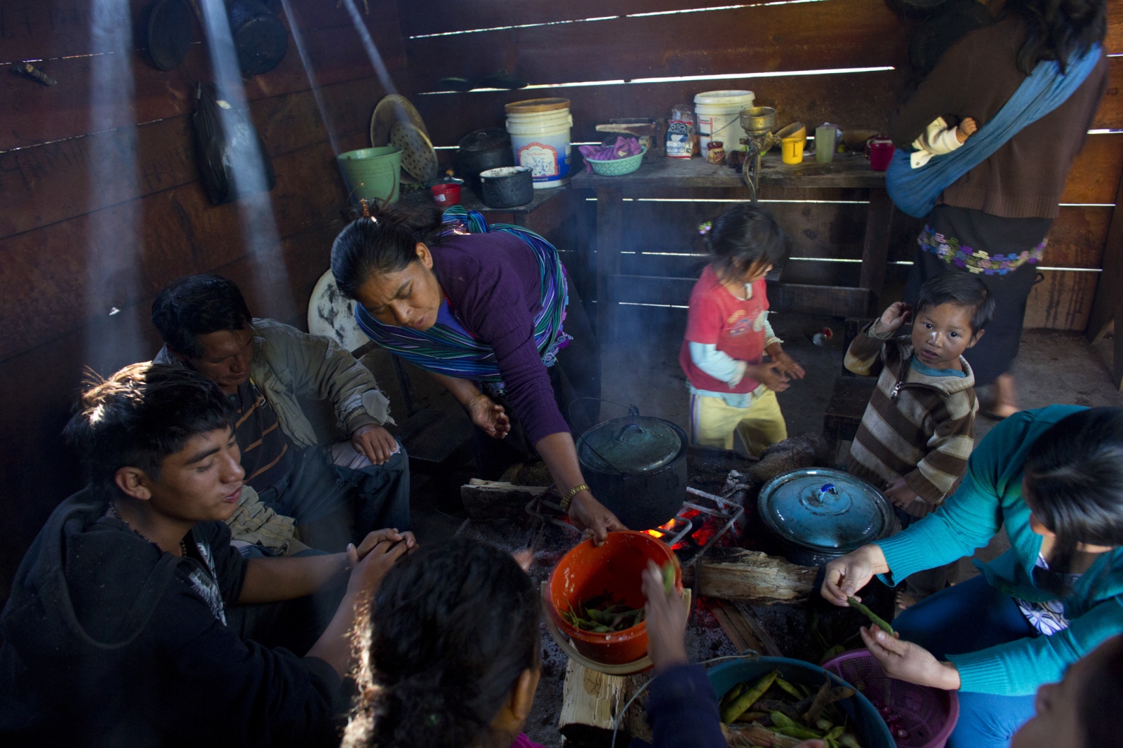 Calling the Midwife, In Chiapas -                   Women prepare food in the kitchen of...