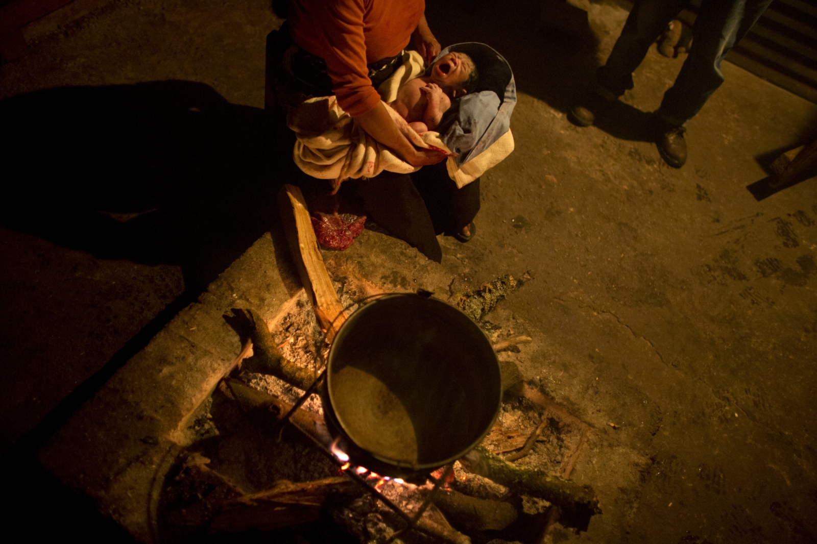 Calling the Midwife, In Chiapas -                   After rushing into the kitchen with a...