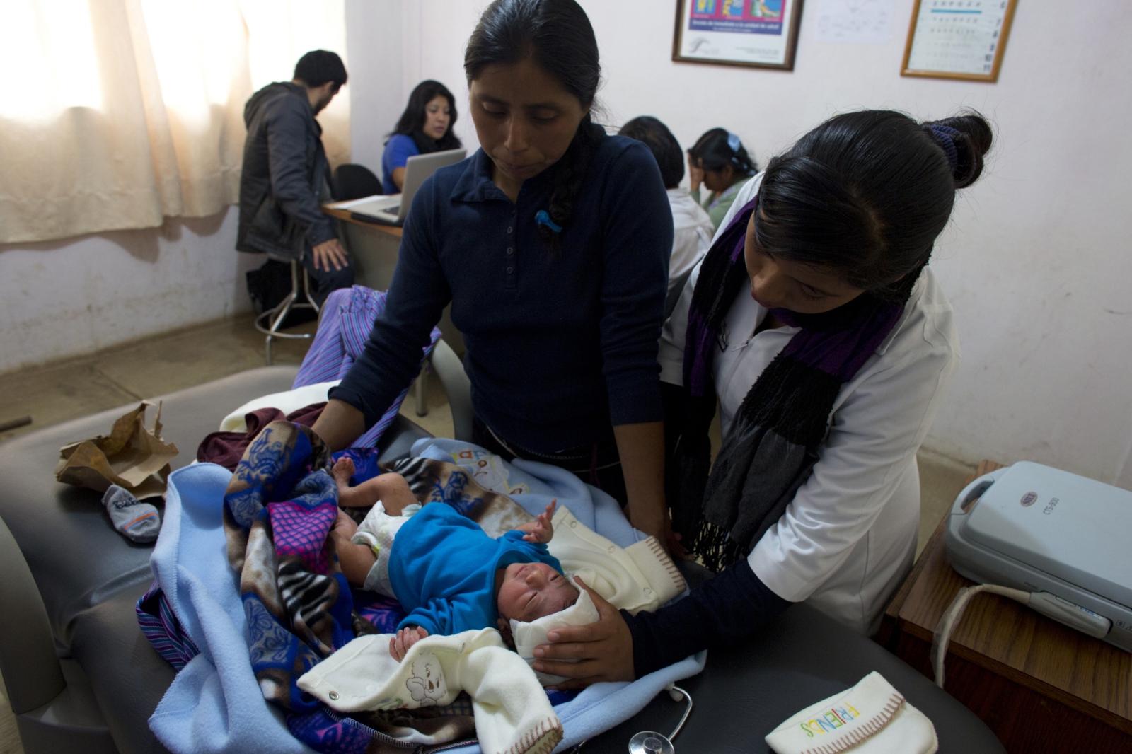 Calling the Midwife, In Chiapas -                   A nurse checks a baby with high fever...