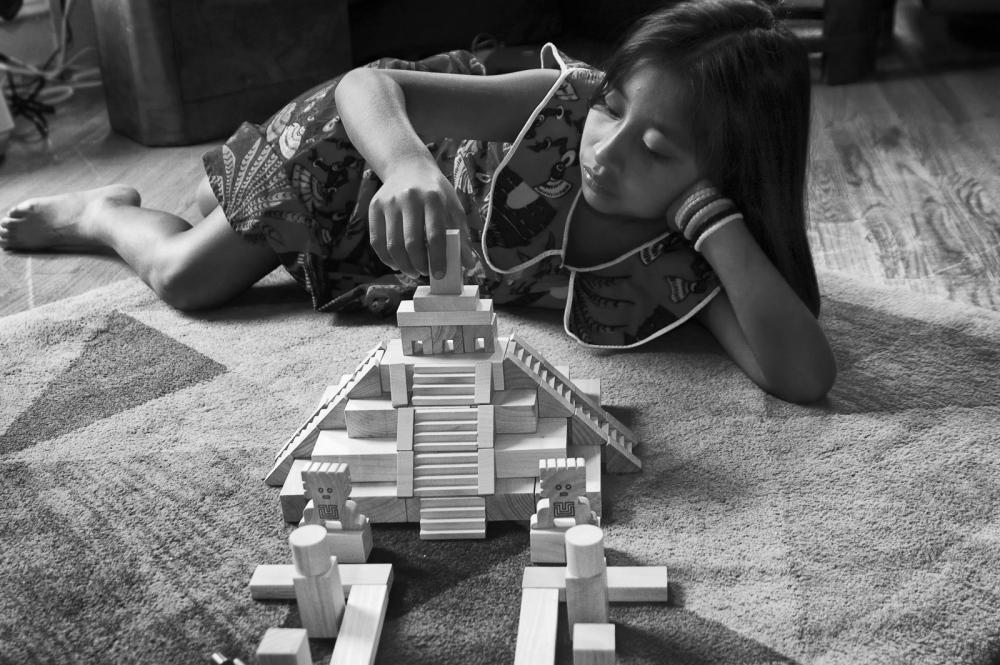  Yasmin constructing a Maya tem... of wooden blocks in Brooklyn. 