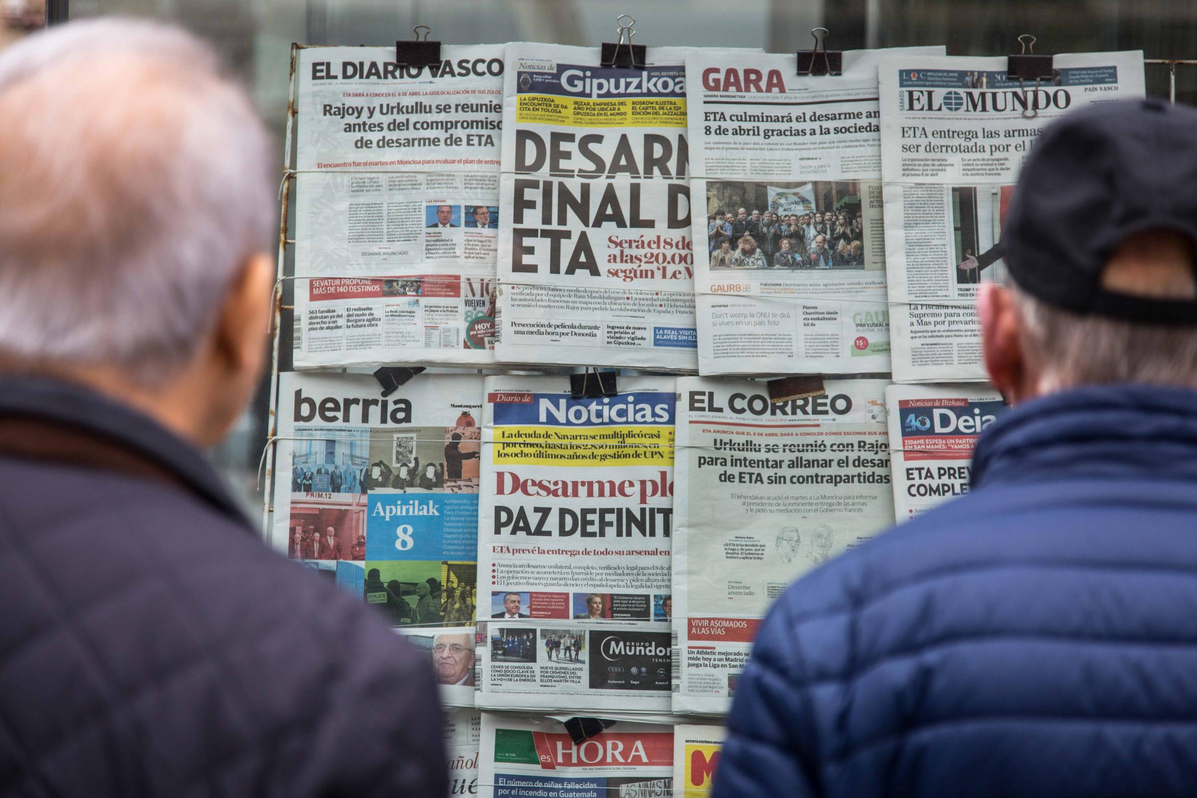Basque Country - A group of people approach to read the headlines of the...