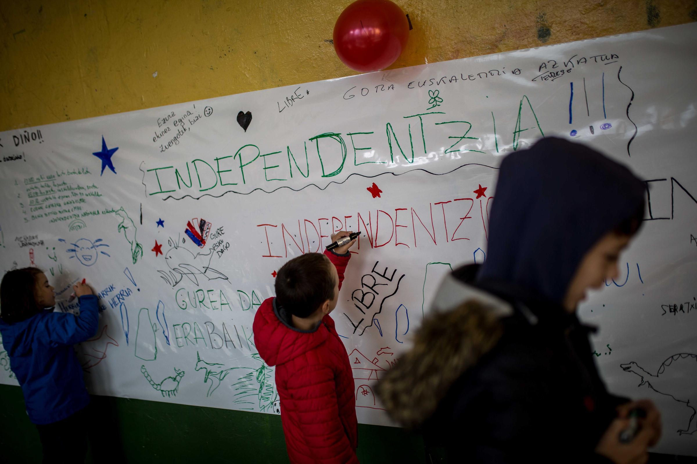 Basque Country - Several children write phrases in favor of Basque independence during a consultation held in...