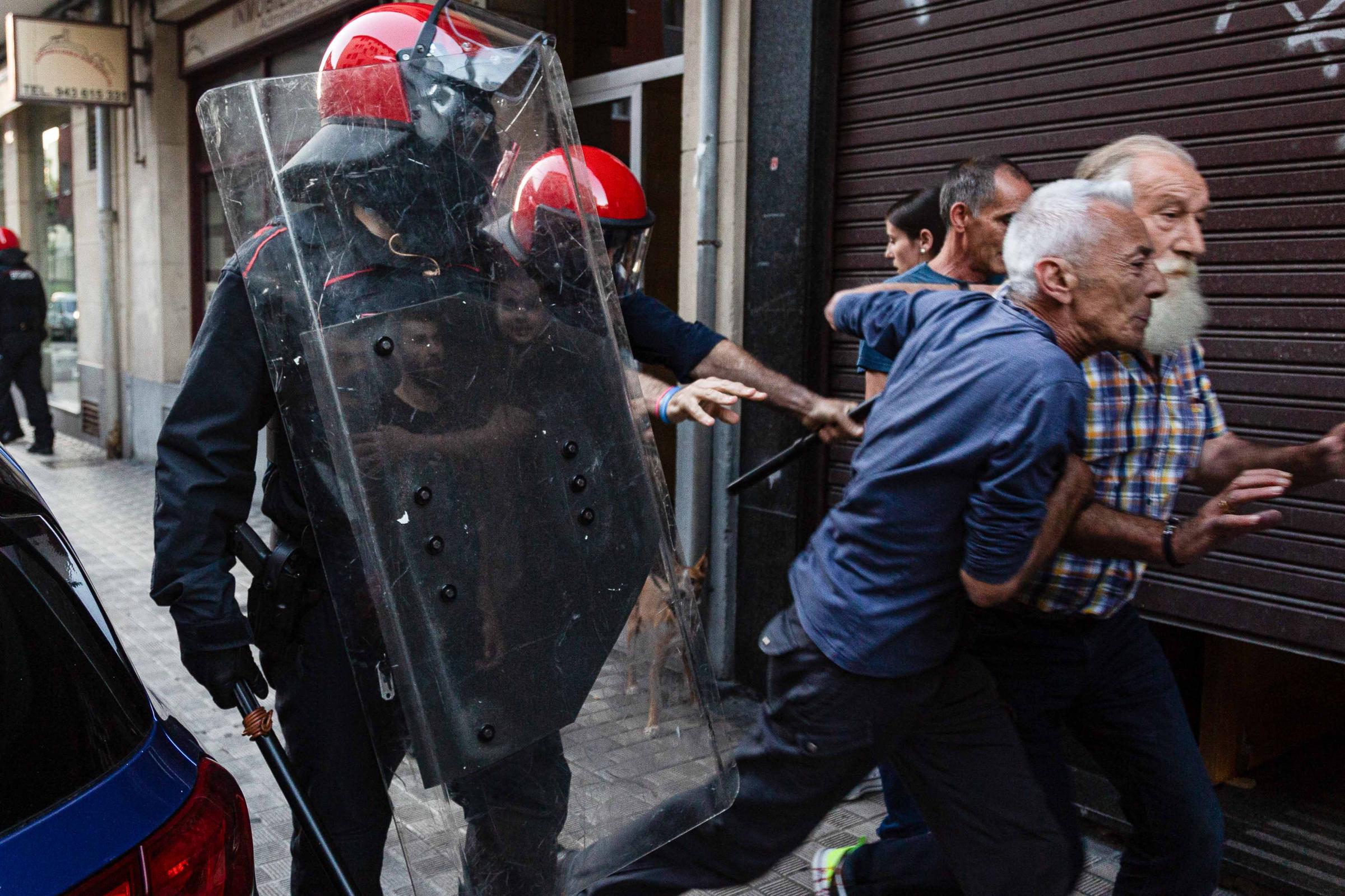 Basque Country -  Members of the Basque police push several people...