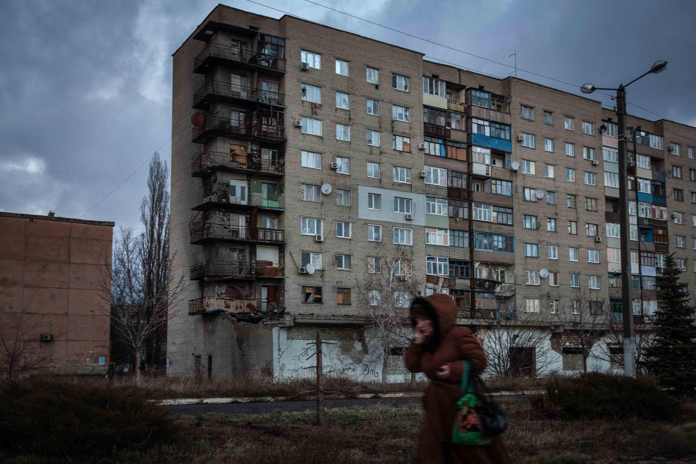 Truce in the Donbas -   December 2014. Lugansk, Ukraine. A woman walks through...