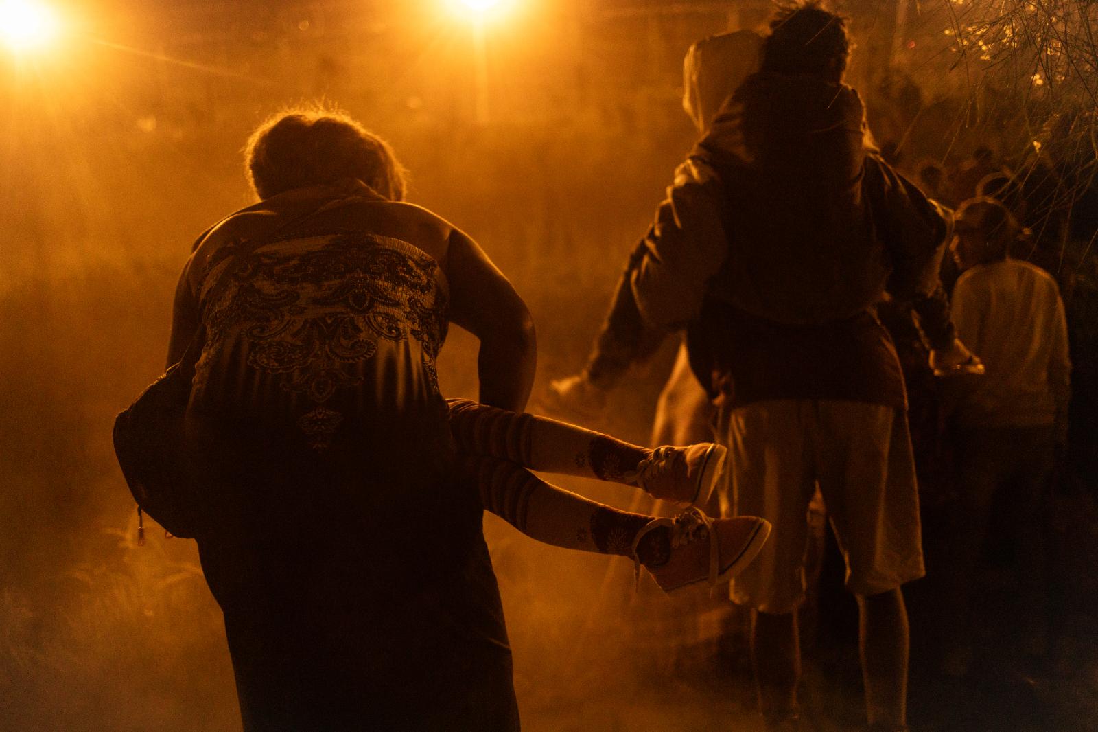  A woman carries a child throug... in search of safety and hope. 
