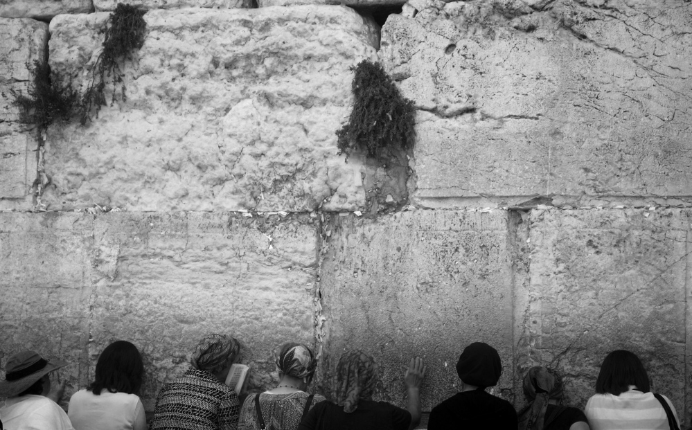  Women pray at the Western Wall...itors are separated by gender. 