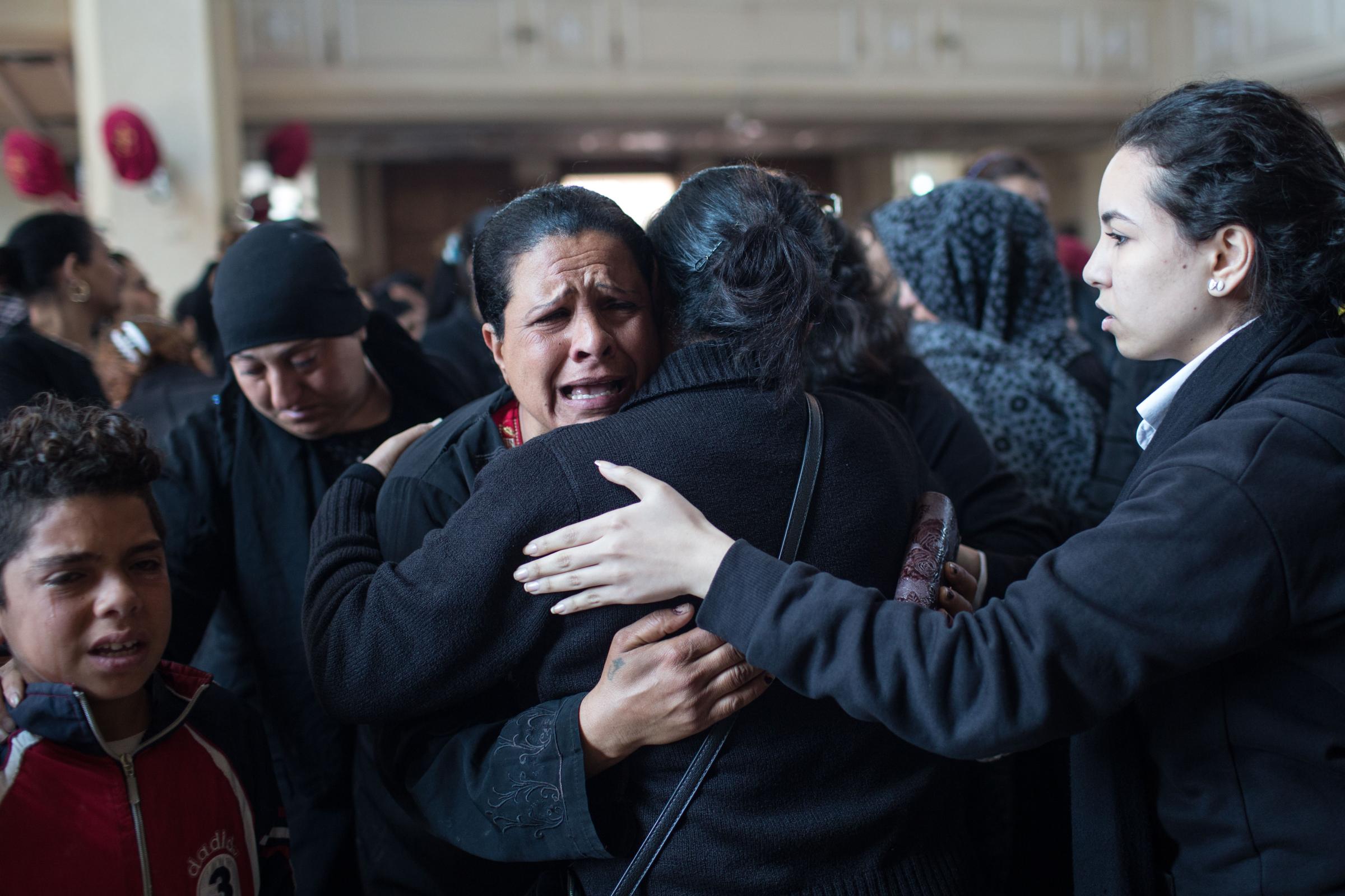  Mourners grieve at the St. Mark and St. Shenouda Church, during the funeral of five victims who drowned at Al Zarayeb area after their homes were...