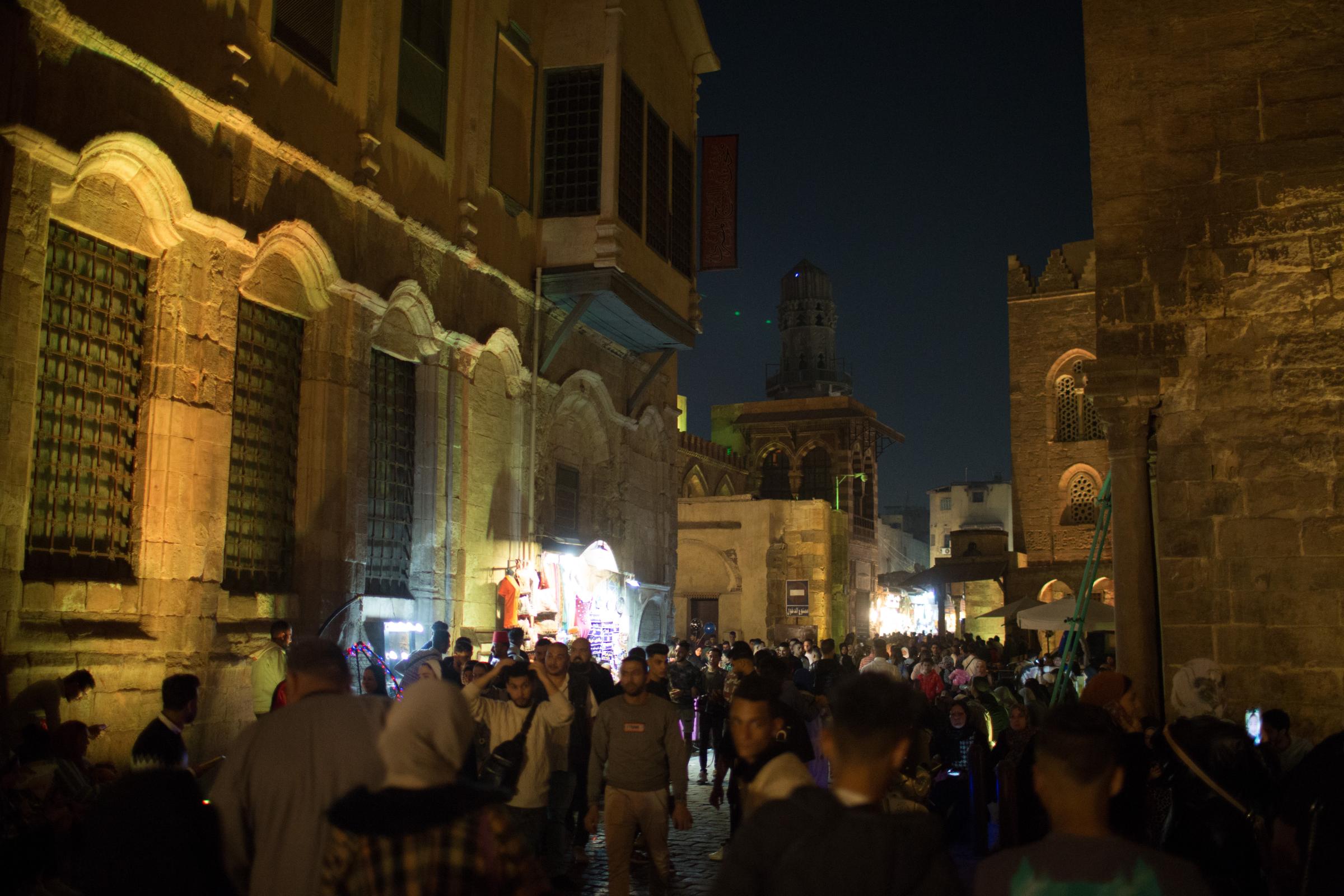 Ramadan in Cairo - People walk next to Islamic and Arabian goods lit with...