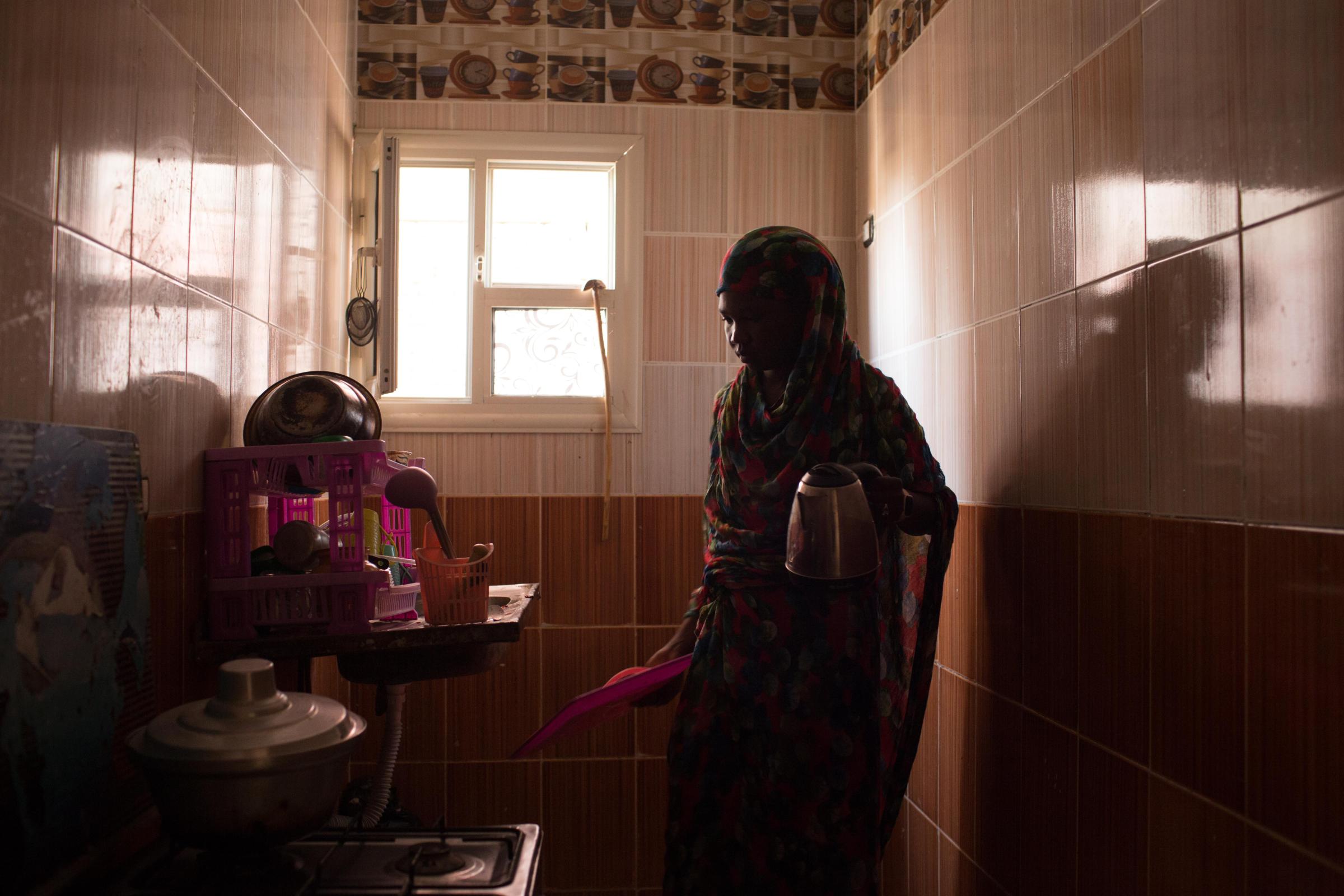 Sudanese head north to Egypt seeking brighter future - Abukk Sebit, 25 years old, prepares food before going to...
