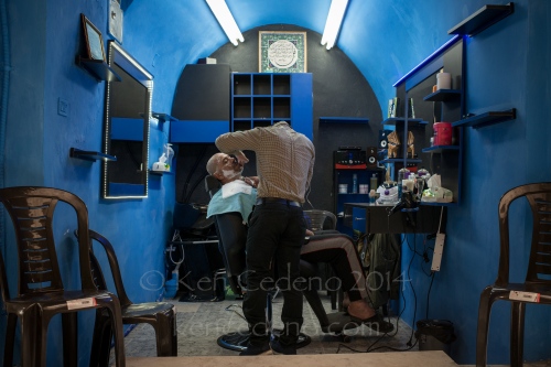 Image from ISRAEL -                 A man gets a close shave in a barber shop...