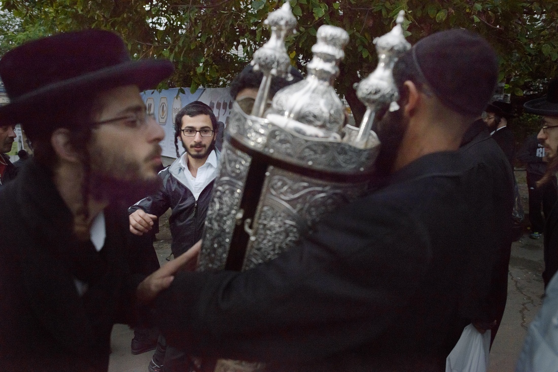 Rosh Hashanah- Ukraine -     Pilgrims kiss the Torah as it is carried down...