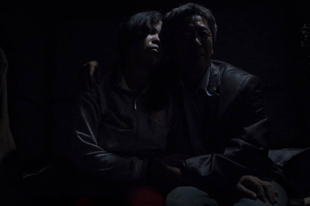 The Price of Happiness [stills] - Buntha, in tears, sits with Zou in bed in the evening....