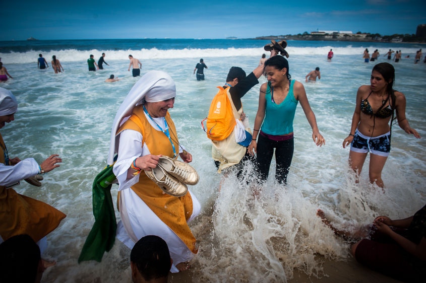     Nuns wade in the Copacabana beach water, in Rio de Janeiro, Brazil, Sunday, July 28, 2013. Pope Francis wrapped up a historic trip to his home continent Sunday with a Mass on the Copacabana beachfront that drew a reported 3Â million people. (AP Photo/Nicolas Tanner)    
