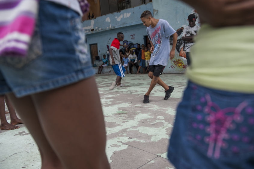  In this Aug. 17, 2013 photo, Marcelly de Mello da Silva, 15, shows off her "passinho," or "little step," moves to a young audience gathered in the Borel favela, in Rio de Janeiro, Brazil. Passinho is a free-form style of dance that is catching on with young people all over the city. The dance borrows from various influences, including samba movements, break dance handstands, and is set to pounding beats on top of soulful hooks. Although Passinho has been around for years, it only recently gained momentum after the baile funk, preferred by drug traffickers, started disappearing during the pacification of the slums.Â 