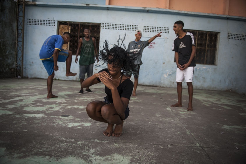  In this Aug. 10, 2013 photo, Marcelly de Mello da Silva, 15, practices her "passinho," or "little step," moves at a makeshift dance studio in the Borel favela, in Rio de Janeiro, Brazil. Passinho is a free-form style of dance that is catching on with young people all over the city. The dance borrows from various influences, including samba movements, break dance handstands, and is set to pounding beats on top of soulful hooks. Although Passinho has been around for years, it only recently gained momentum after the baile funk, preferred by drug traffickers, started disappearing during the pacification of the slums. 