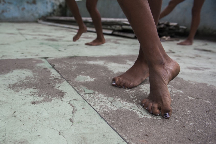  In this Aug. 17, 2013 photo, Marcelly de Mello da Silva, 15, leads a "passinho," or "little step," instruction session at a makeshift dance studio in the Borel favela, in Rio de Janeiro, Brazil. Passinho is a free-form style of dance that is catching on with young people all over the city. The dance borrows from various influences, including samba movements, break dance handstands, and is set to pounding beats on top of soulful hooks. Although Passinho has been around for years, it only recently gained momentum after the baile funk, preferred by drug traffickers, started disappearing during the pacification of the slums. 