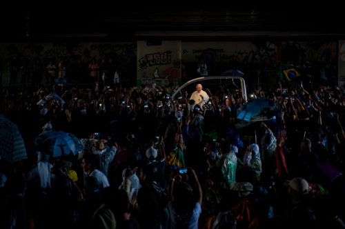      People greet Pope Francis as he travels through a road tunnel in his pope-mobile in Rio de Janeiro, Brazil, early Saturday, July 27, 2013. Pope Francis on Saturday challenged bishops from around the world to get out of their churches and preach, and to have the courage to go to the farthest margins of society to find the faithful.     