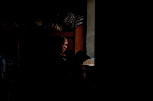     An uzbek woman searches for documents in her home in Osh, Kyrgyzstan in November 2011.    