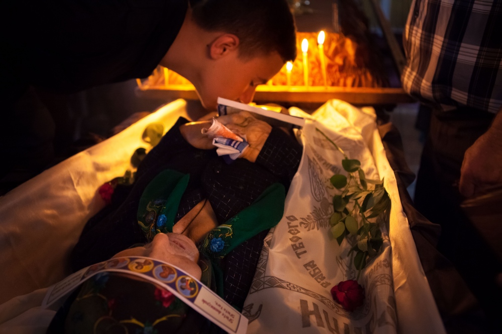 Boy kisses his grandmother at he_common Moldovan religious custom