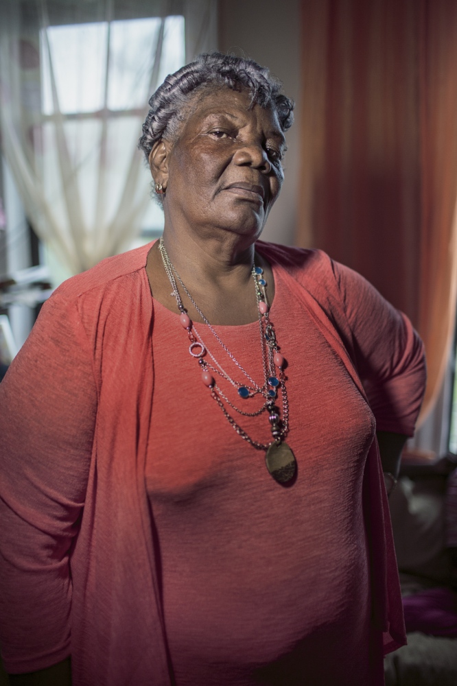  Granma Azucena stands in the living room of her apartment in the South Bronx. She came to the...